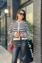 a lady in a striped cardigan and a pair of PU leather pants